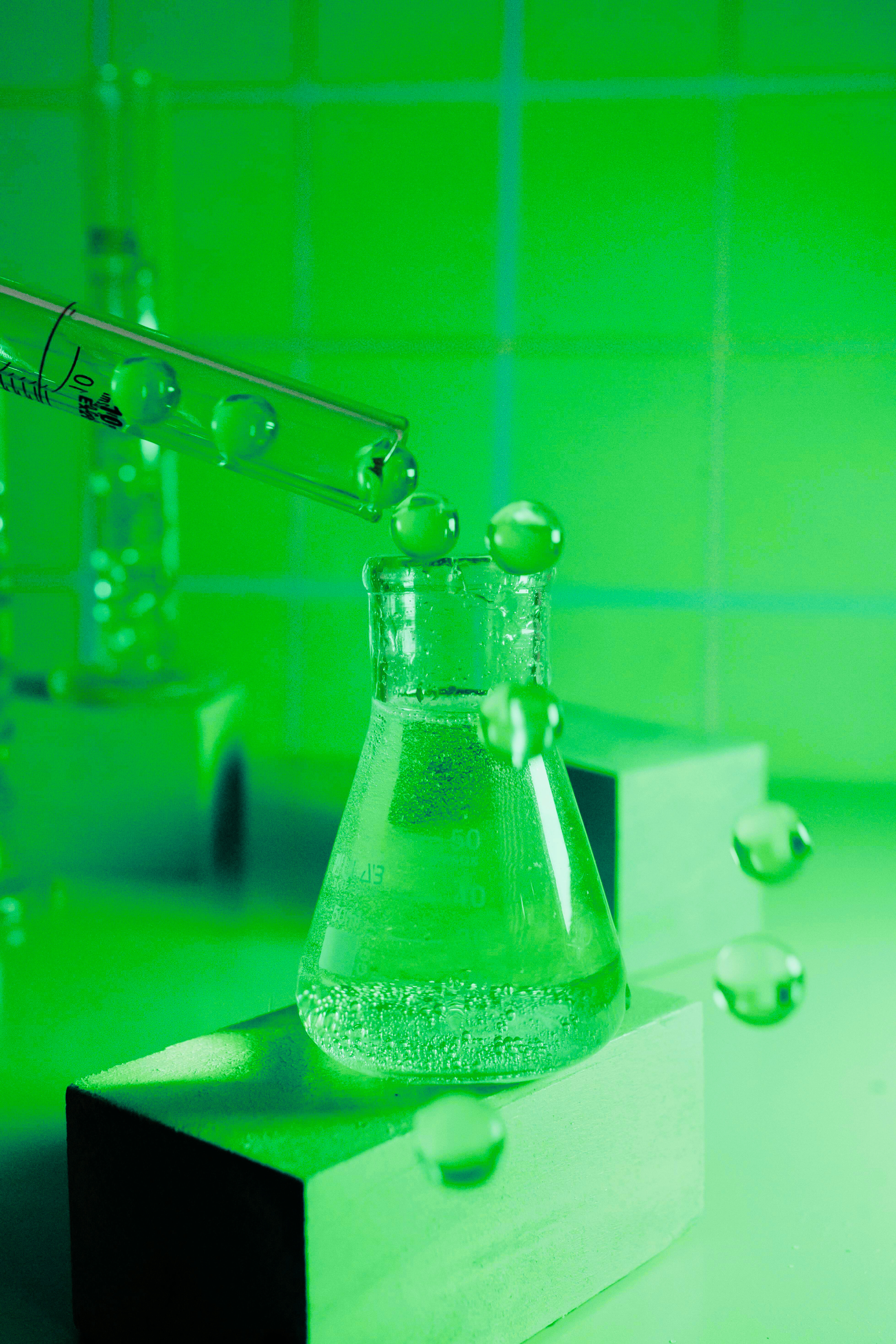 Blue chemical splash and glass bottle